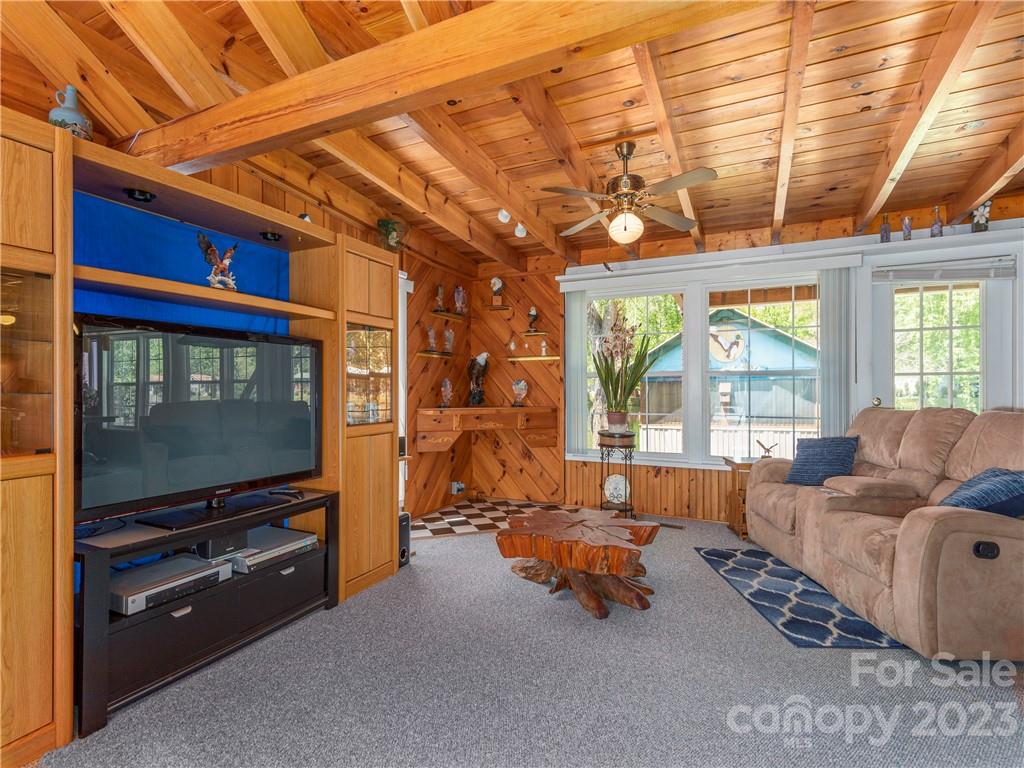 258 Mallard Loop Waynesville, NC 28785 - Photo 6 of 22 a living room with furniture a flat screen tv and large windows