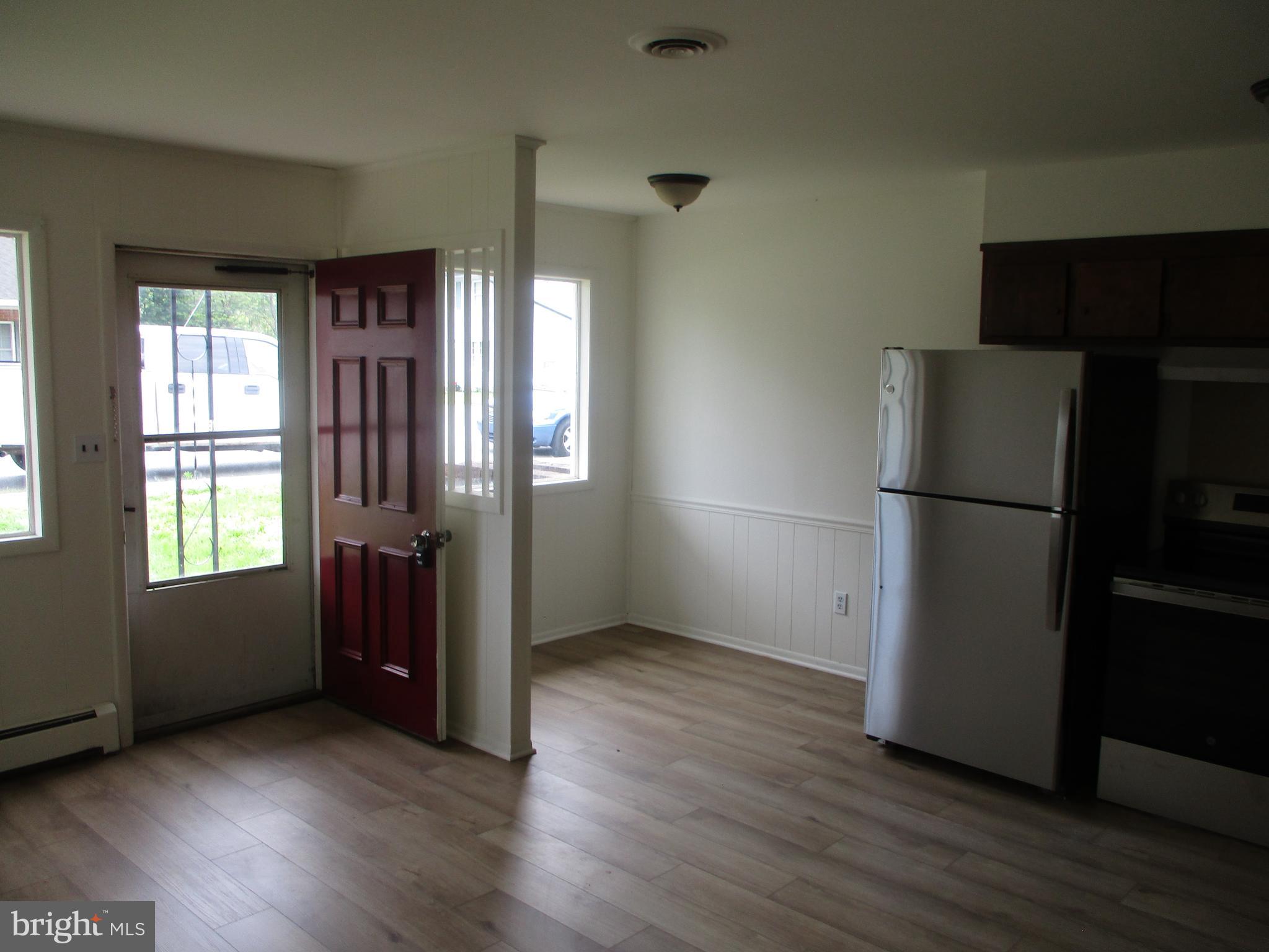 1 Fleming Drive, Unit B Hancock, MD 21750 - Photo 4 of 14 a view of an empty room with a window and wooden floor