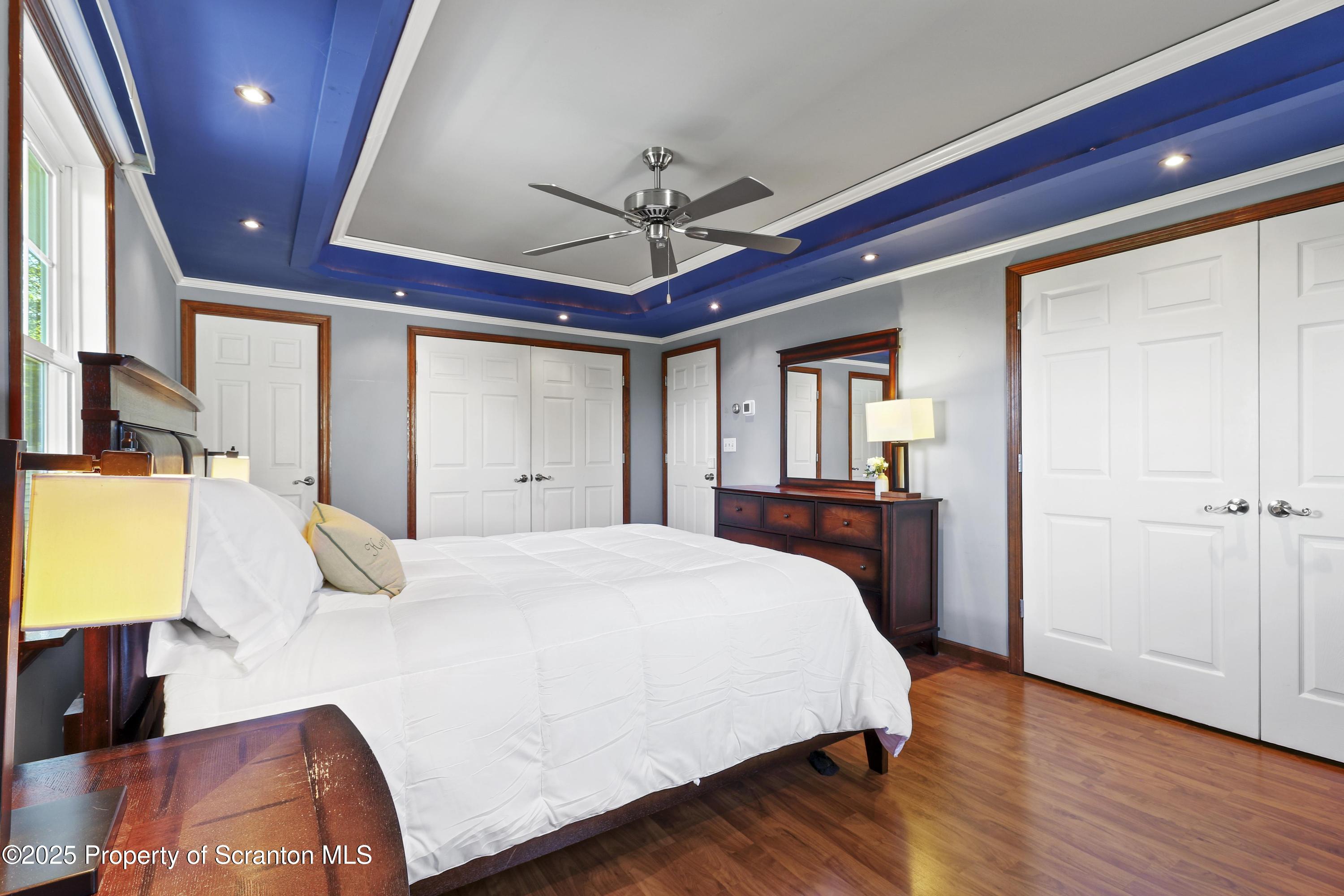 123 Ridgeview Drive Scranton, PA 18504 - Photo 35 of 53 a bedroom with a large bed and a chandelier
