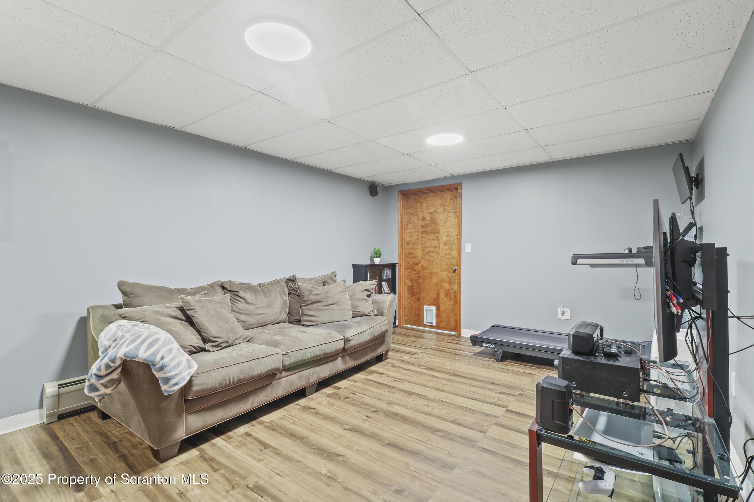 123 Ridgeview Drive Scranton, PA 18504 - Photo 45 of 53 a living room with furniture a flat screen tv and a table