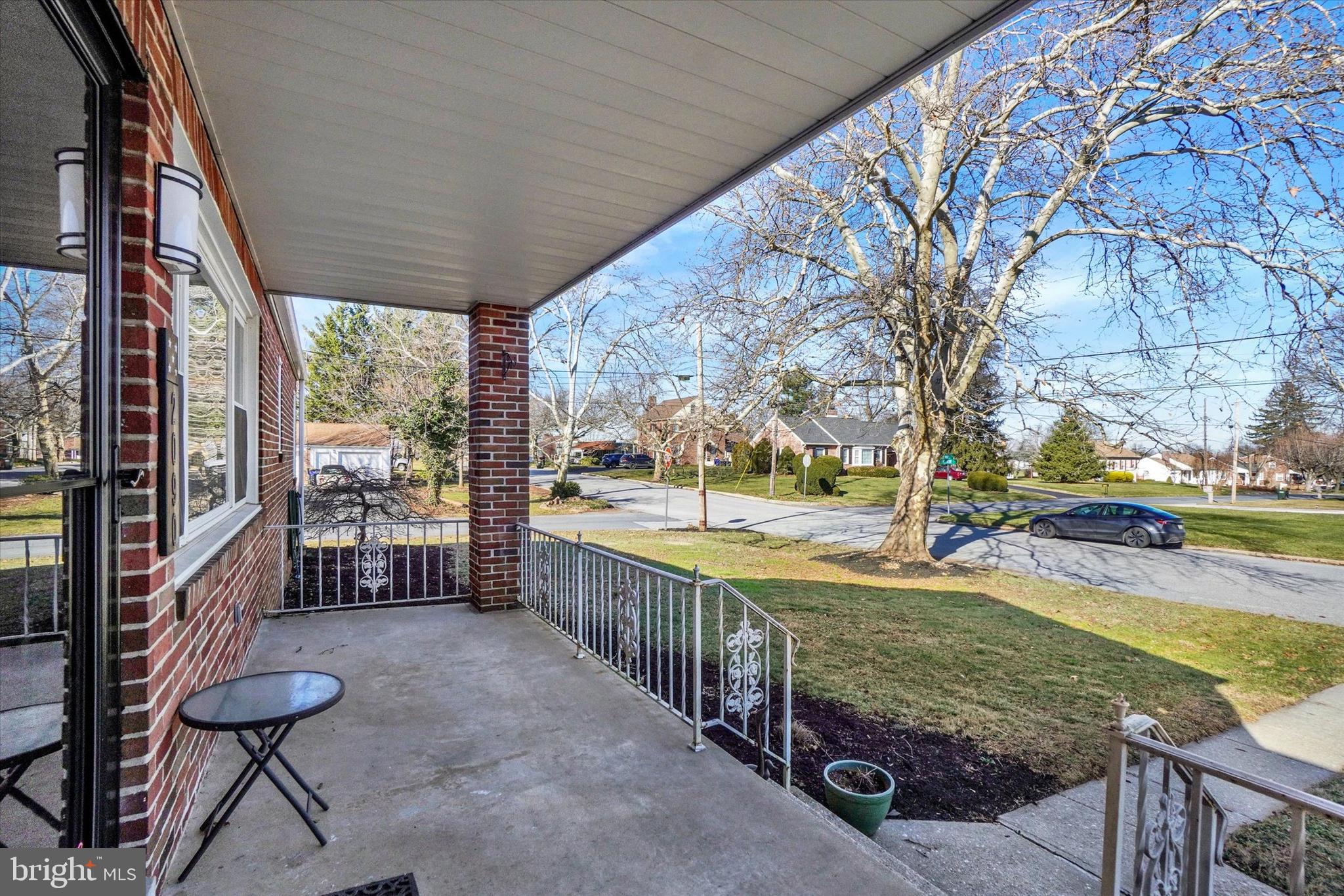 2090 Sycamore Road York, PA 17408 - Photo 3 of 27 a view of a patio with table and chairs potted plants and large tree