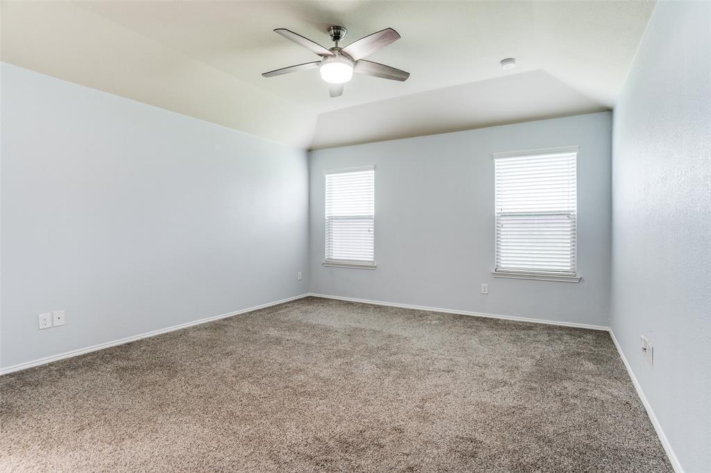 513 Wichita Trail McKinney, TX 75071 - Photo 4 of 12 an empty room with windows and fan