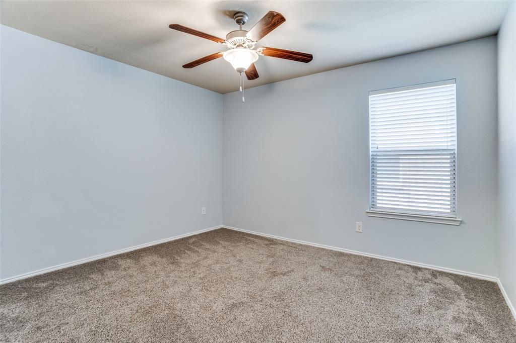 513 Wichita Trail McKinney, TX 75071 - Photo 5 of 12 an empty room with a window and a ceiling fan
