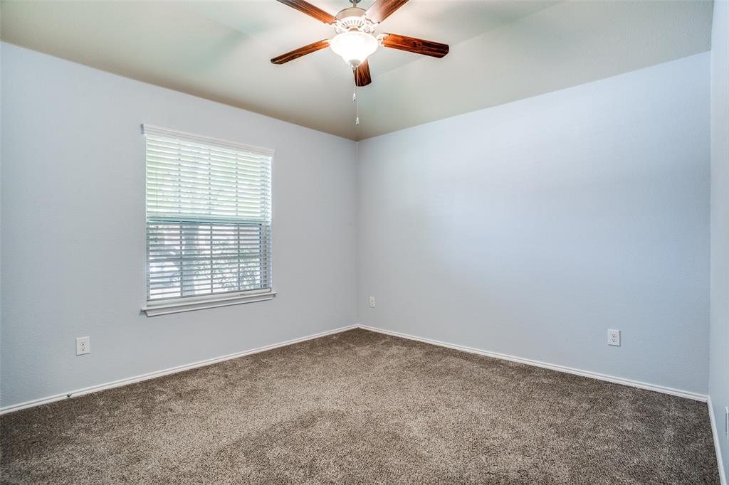 513 Wichita Trail McKinney, TX 75071 - Photo 6 of 12 an empty room with a window and a fan