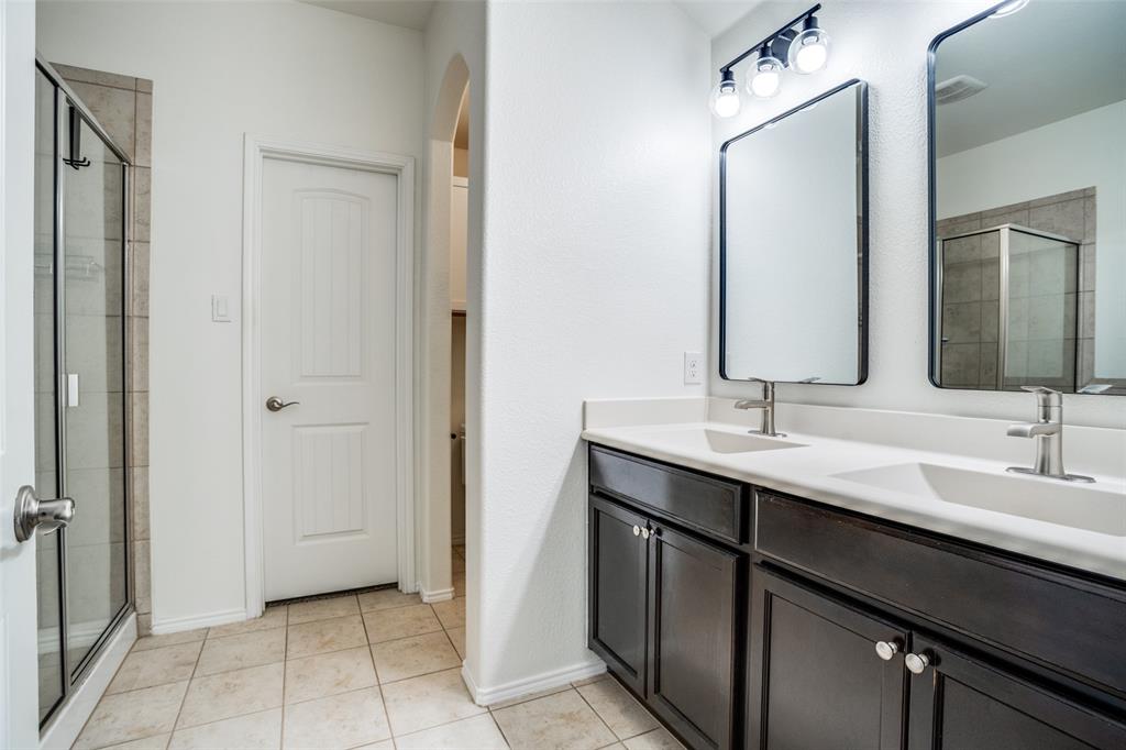 513 Wichita Trail McKinney, TX 75071 - Photo 7 of 12 a bathroom with a double vanity sink and a mirror