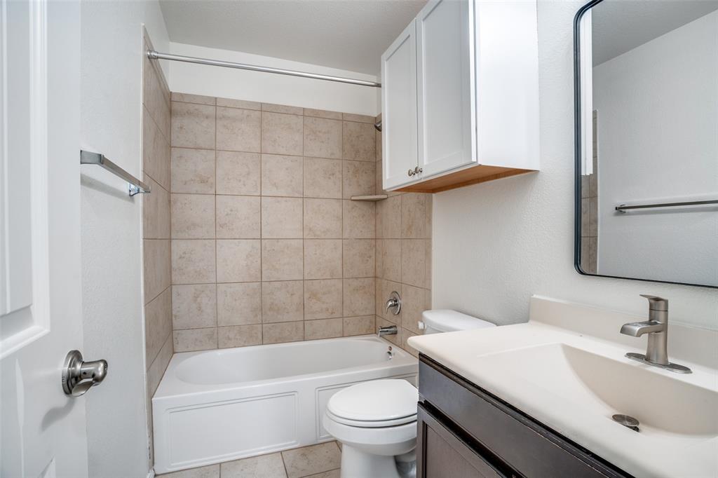 513 Wichita Trail McKinney, TX 75071 - Photo 8 of 12 a bathroom with a sink a toilet and shower
