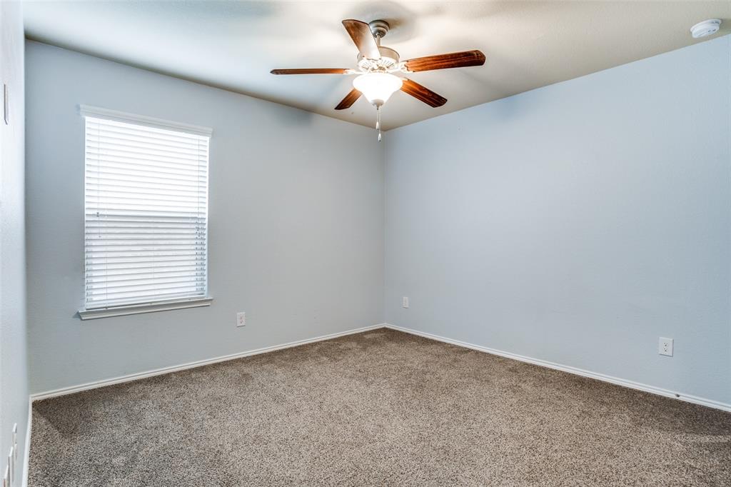 513 Wichita Trail McKinney, TX 75071 - Photo 9 of 12 an empty room with windows and fan