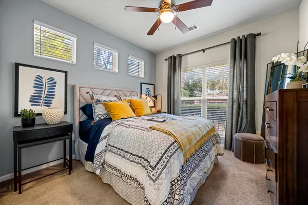 a bedroom with a bed and a chandelier