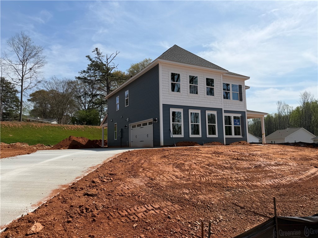 This newly constructed home features a classic exterior and attached garage, ready for your personal touch.