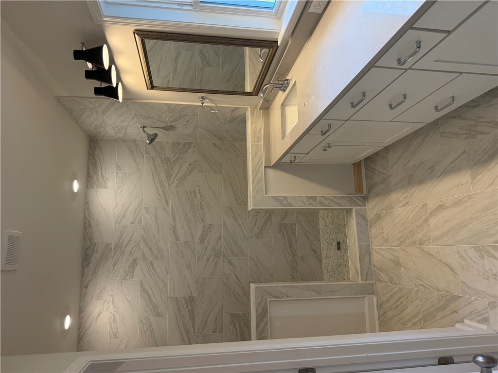 405 Botany Lane Anderson, SC 29621 - Photo 11 of 14 This bathroom features elegant tiling and a spacious vanity, offering a serene and functional retreat.