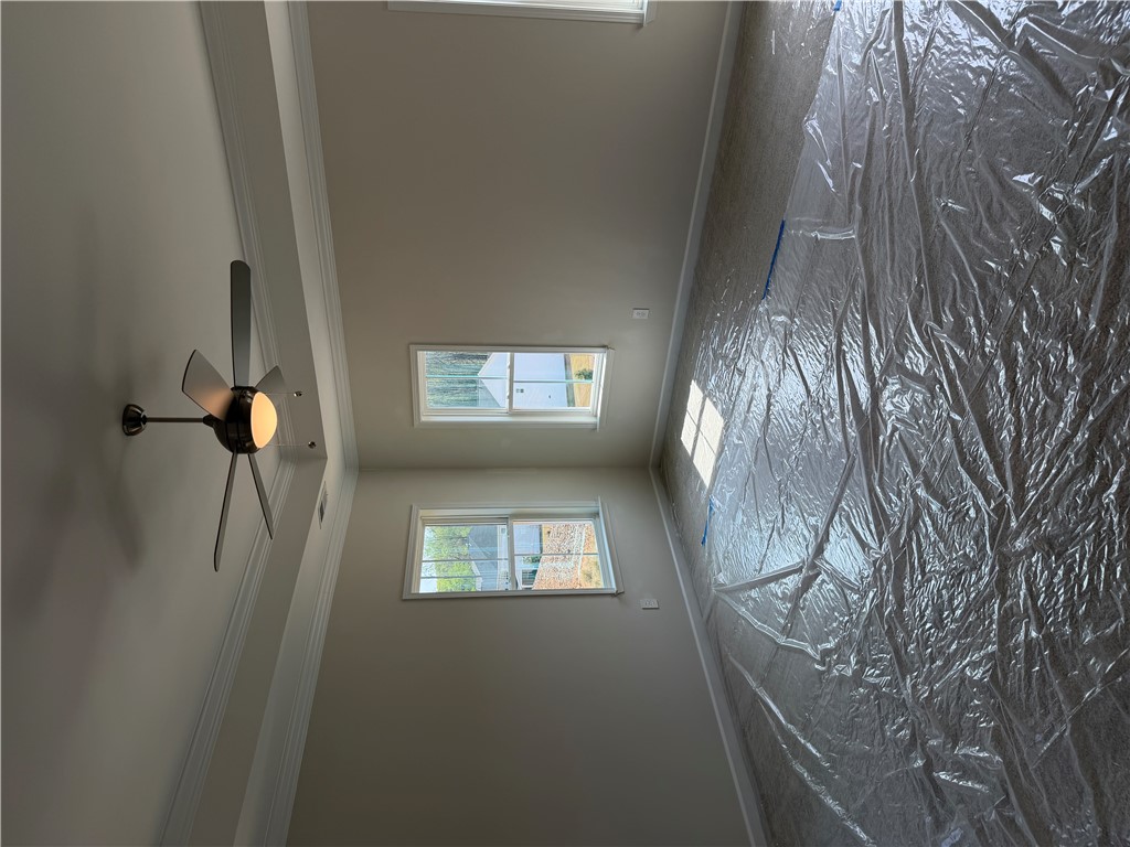 405 Botany Lane Anderson, SC 29621 - Photo 10 of 14 This living area features a high ceiling, crown molding, and bright windows, ready for personalization.