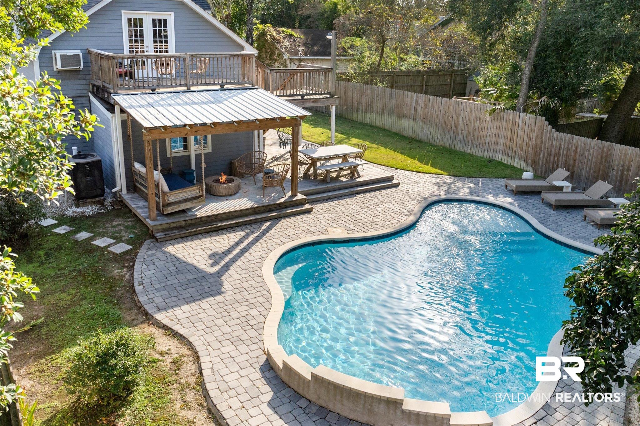 1210 Government Street Mobile, AL 36604 - Photo 23 of 37 View of swimming pool featuring an AC wall unit, a wooden deck, and central AC