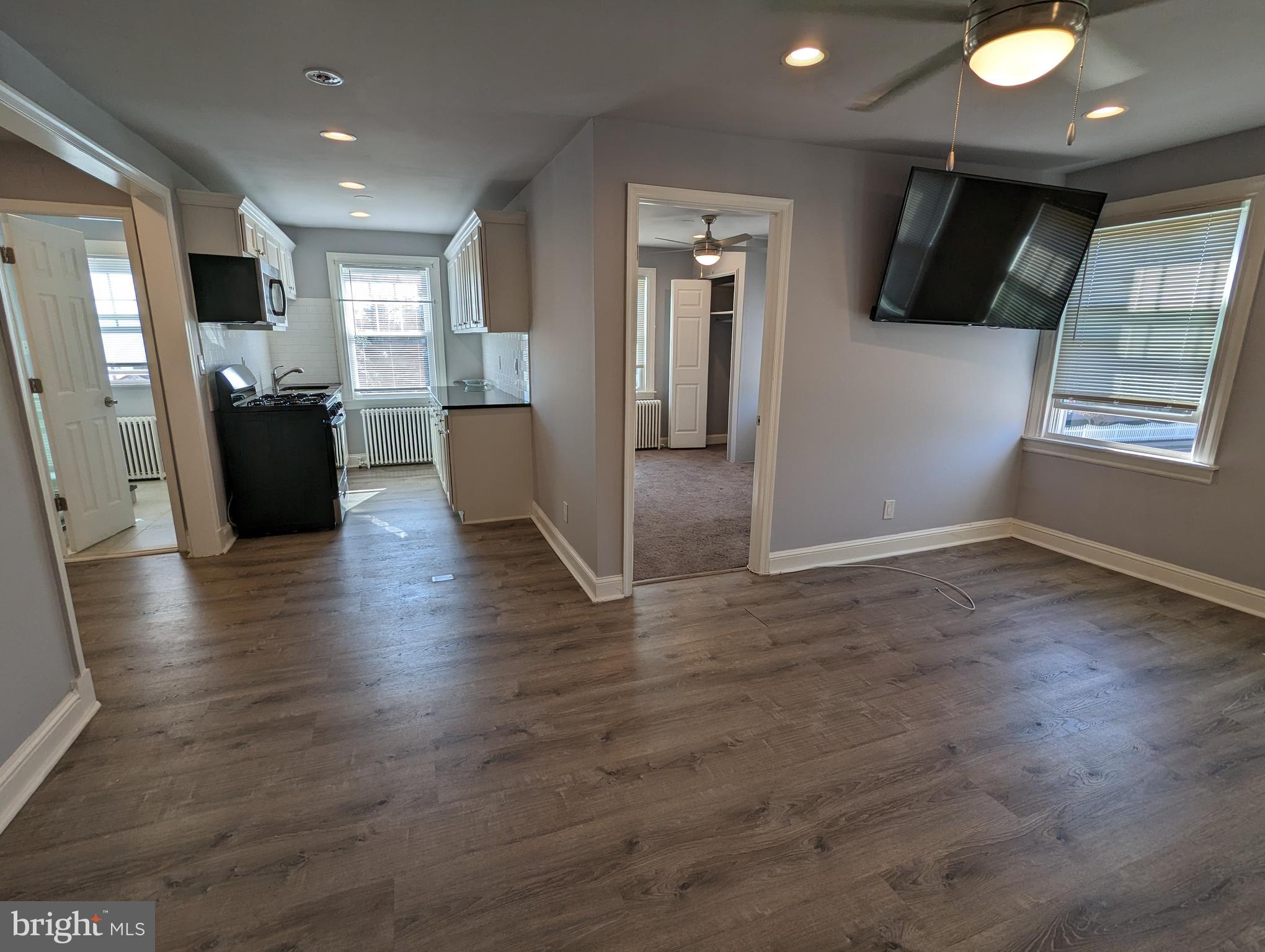 401 Montgomery Street, Unit 2 Laurel, MD 20707 - Photo 3 of 13 an open space with kitchen view and wooden floor