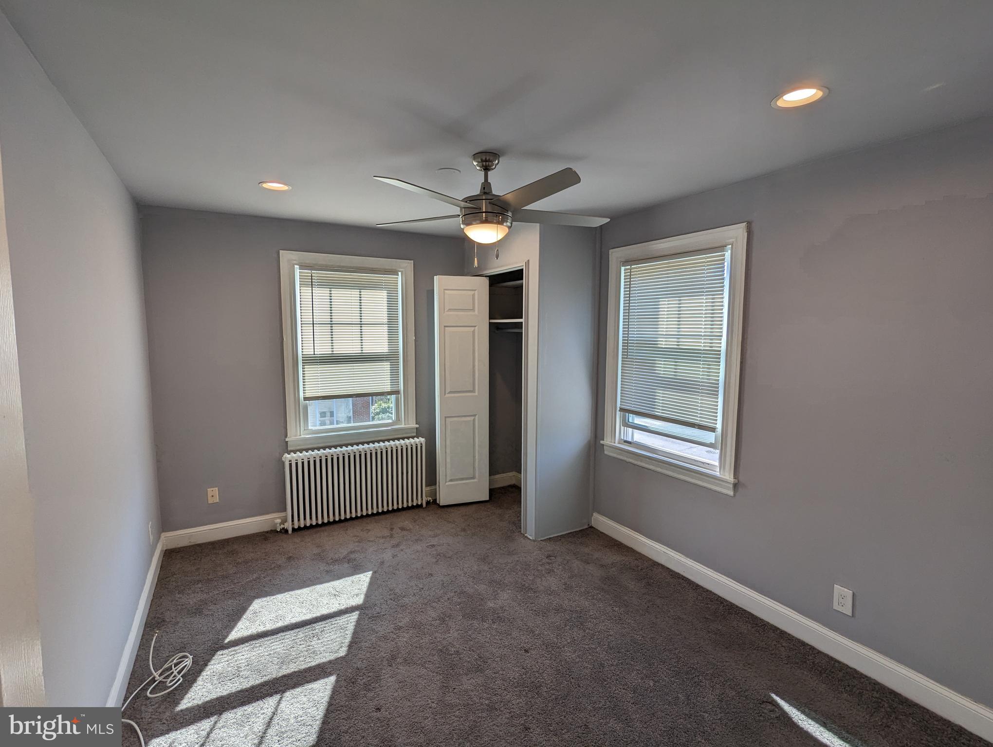 401 Montgomery Street, Unit 2 Laurel, MD 20707 - Photo 10 of 13 en empty room with windows and ceiling fan