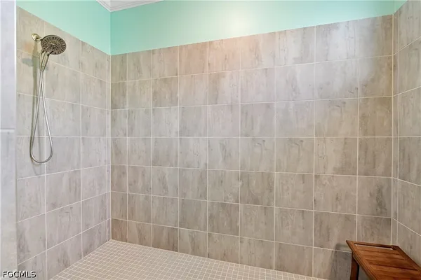 a spacious bathroom with a shower sink and mirror