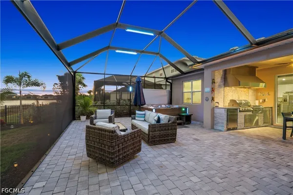 a living room with patio furniture and a umbrella