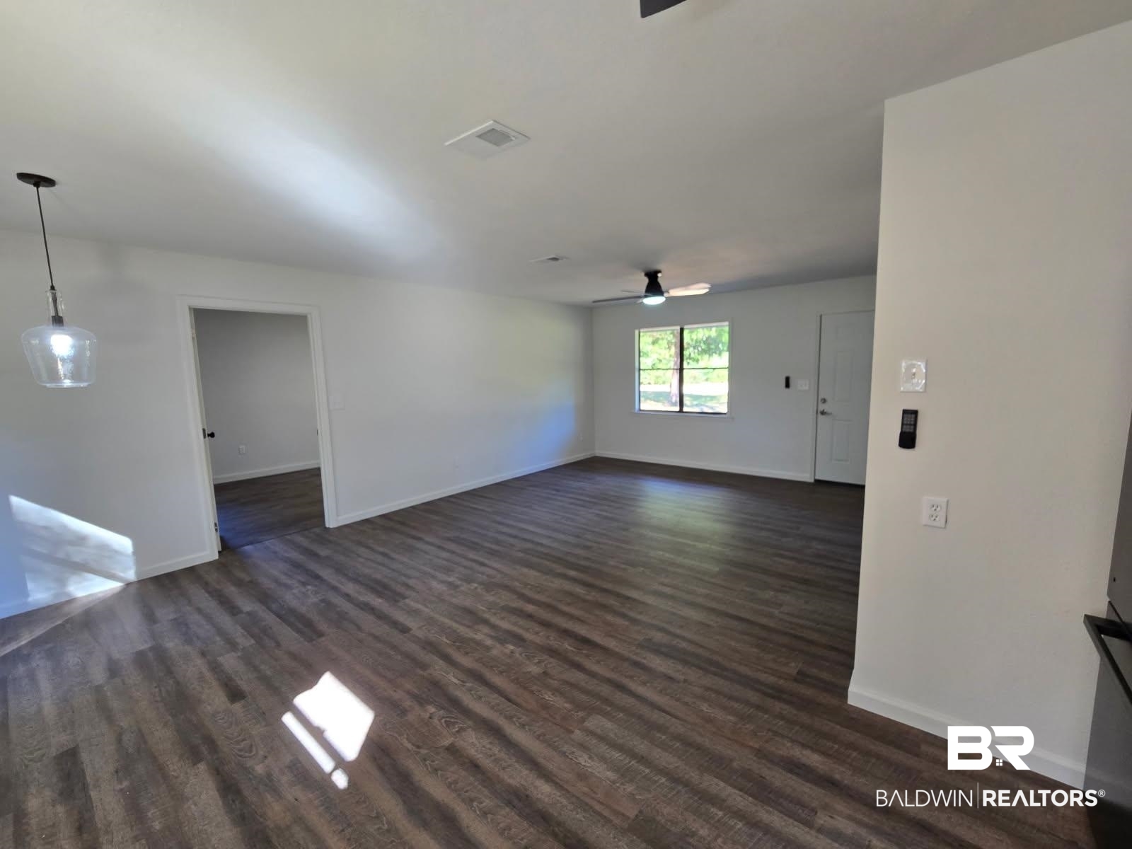 1404 Dailey Street Brewton, AL 36426 - Photo 6 of 25 Unfurnished living room with dark wood-type flooring and a ceiling fan
