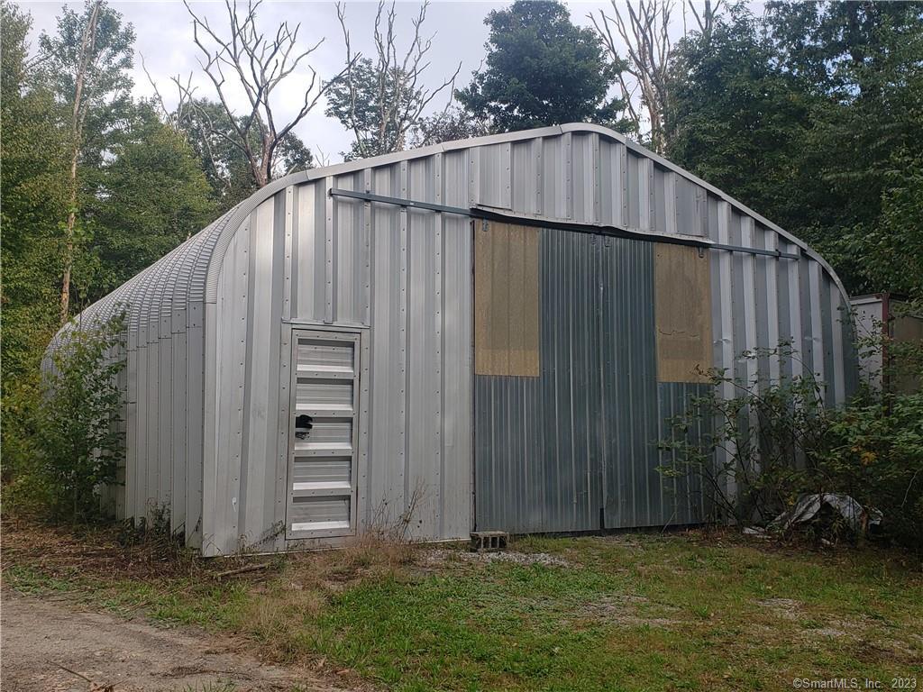63 Gay Head Road Canterbury, CT 06331 - Photo 3 of 4 a backyard of a house with plants and large tree