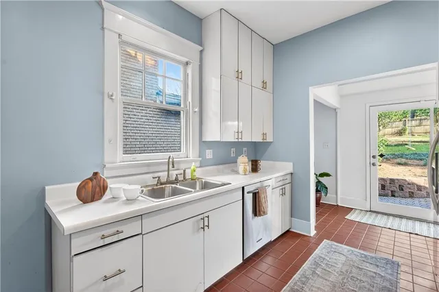 a kitchen with stainless steel appliances granite countertop a refrigerator a stove and a sink