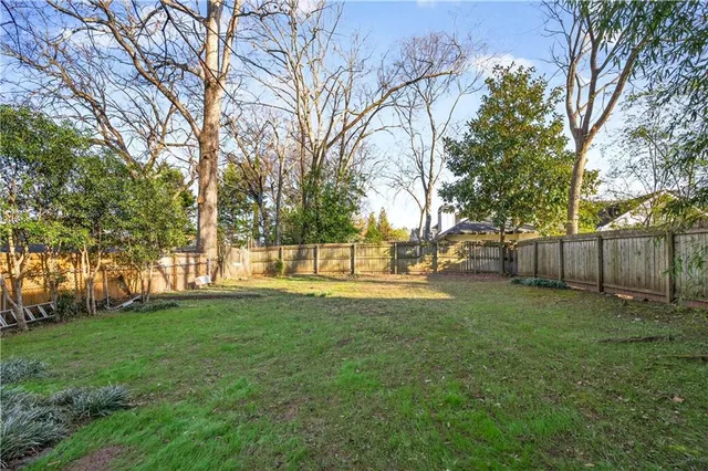 a view of a house with a yard and tree s