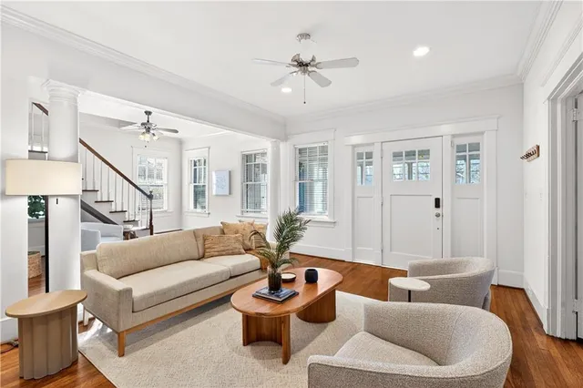a living room with furniture and a ceiling fan