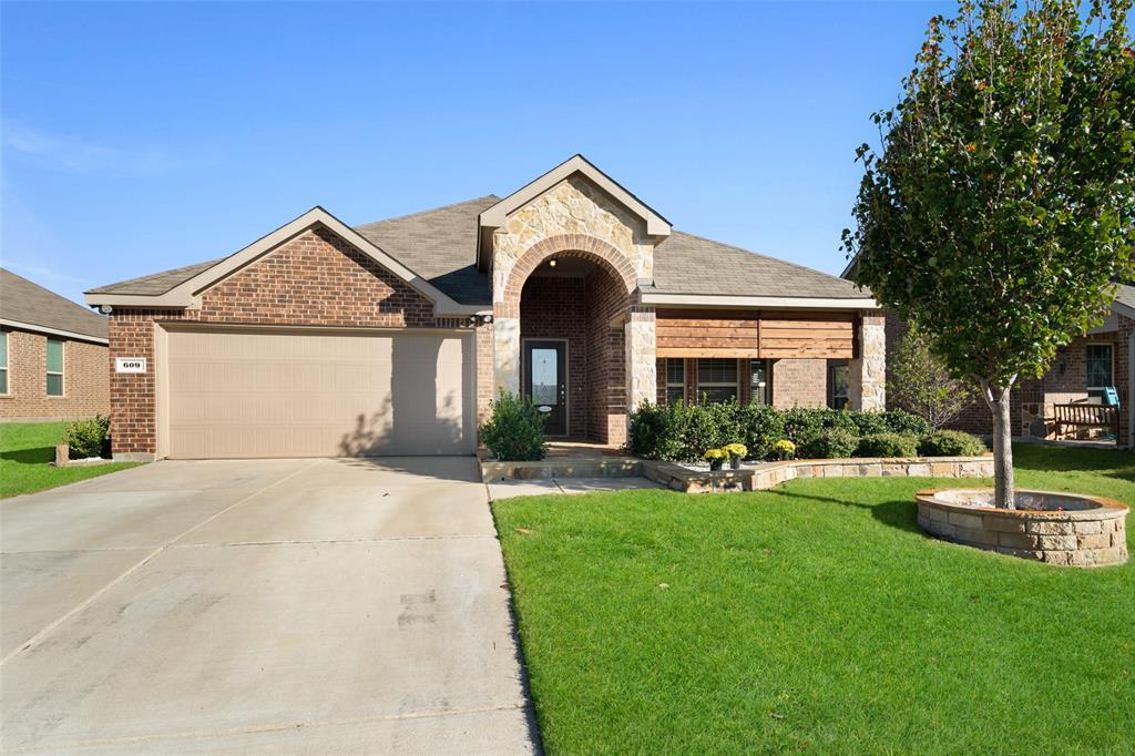 609 Racine Drive Oak Point, TX 75068 - Photo 1 of 1 a front view of a house with garden and trees