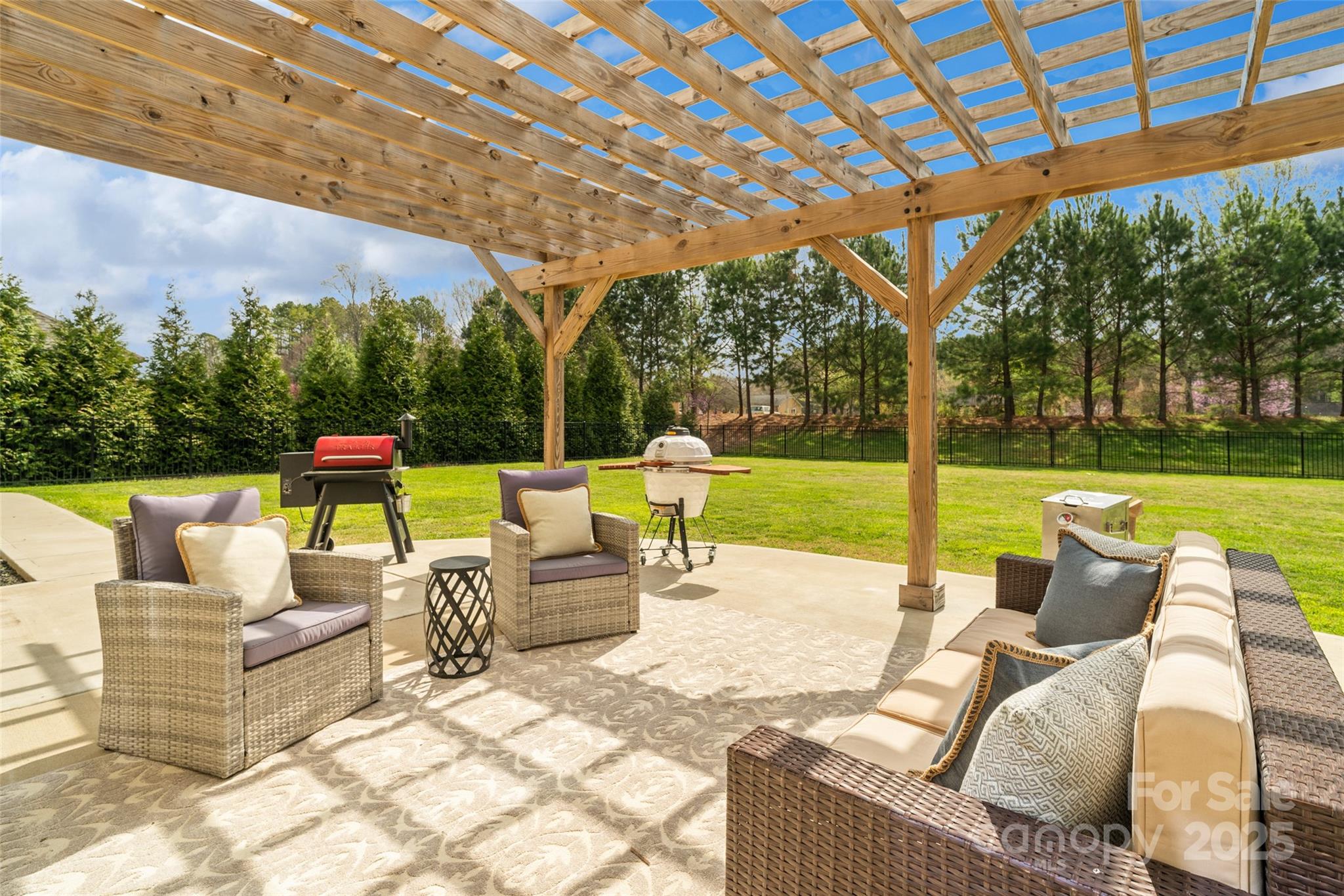 1022 Torrens Drive Monroe, NC 28110 - Photo 14 of 46 a view of a patio with couches and chairs under an umbrella