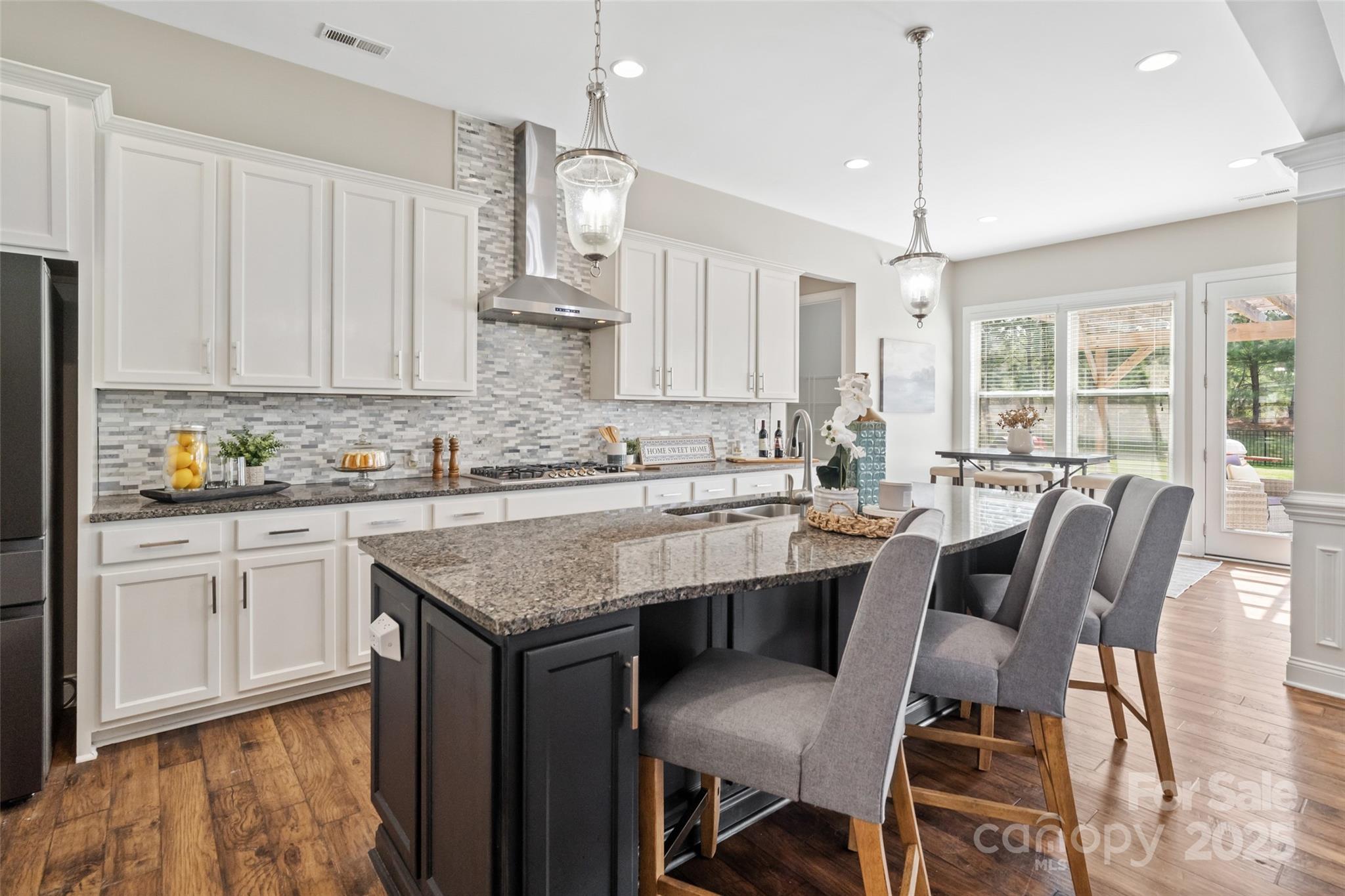 1022 Torrens Drive Monroe, NC 28110 - Photo 21 of 46 a kitchen with a table chairs sink and cabinets