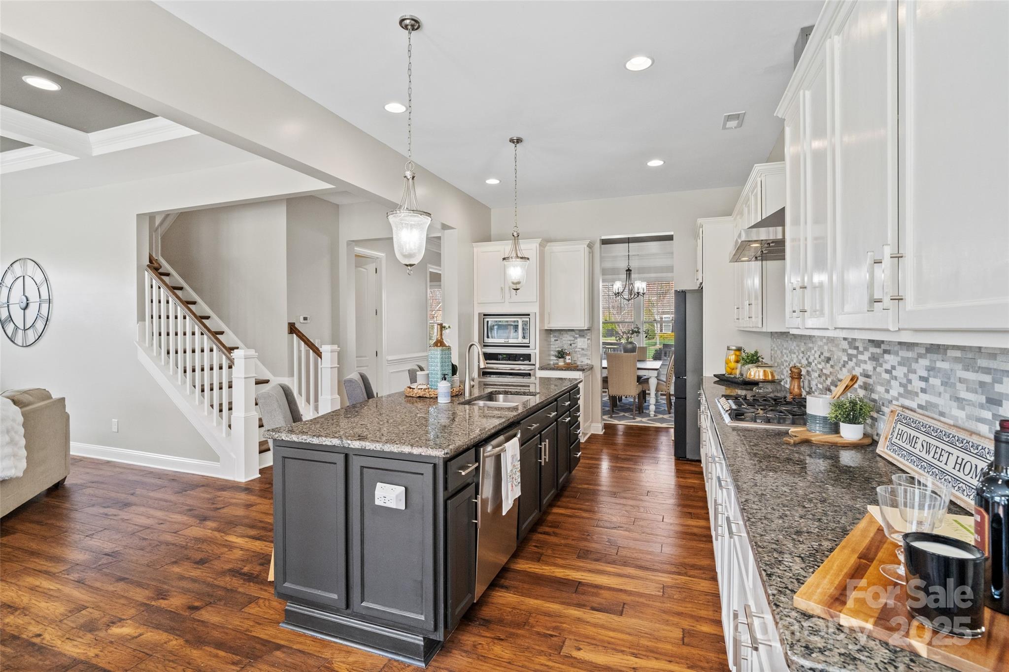 1022 Torrens Drive Monroe, NC 28110 - Photo 23 of 46 a kitchen with stainless steel appliances granite countertop a stove and a wooden floors