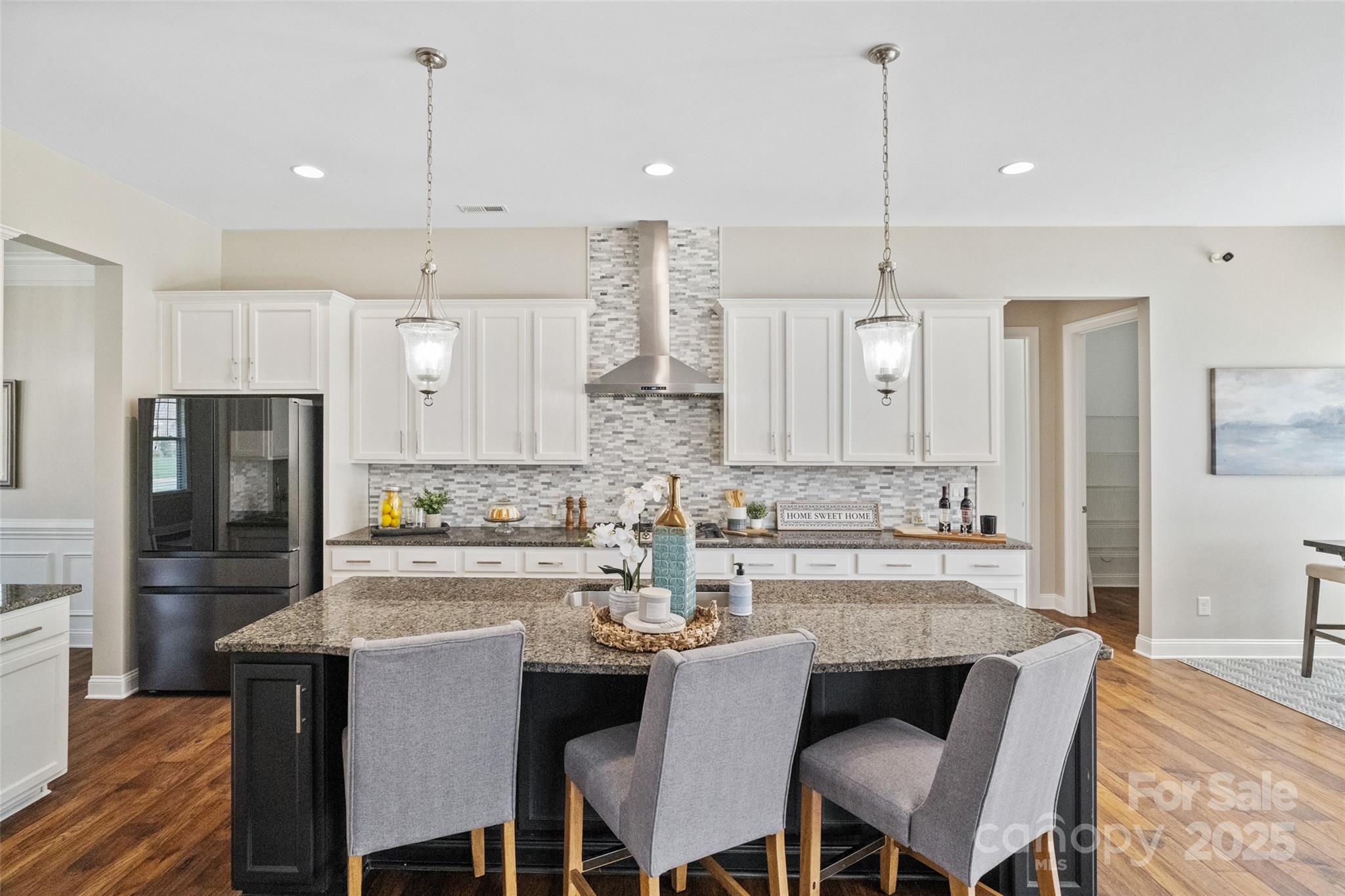 1022 Torrens Drive Monroe, NC 28110 - Photo 26 of 46 a kitchen with refrigerator a sink and chairs