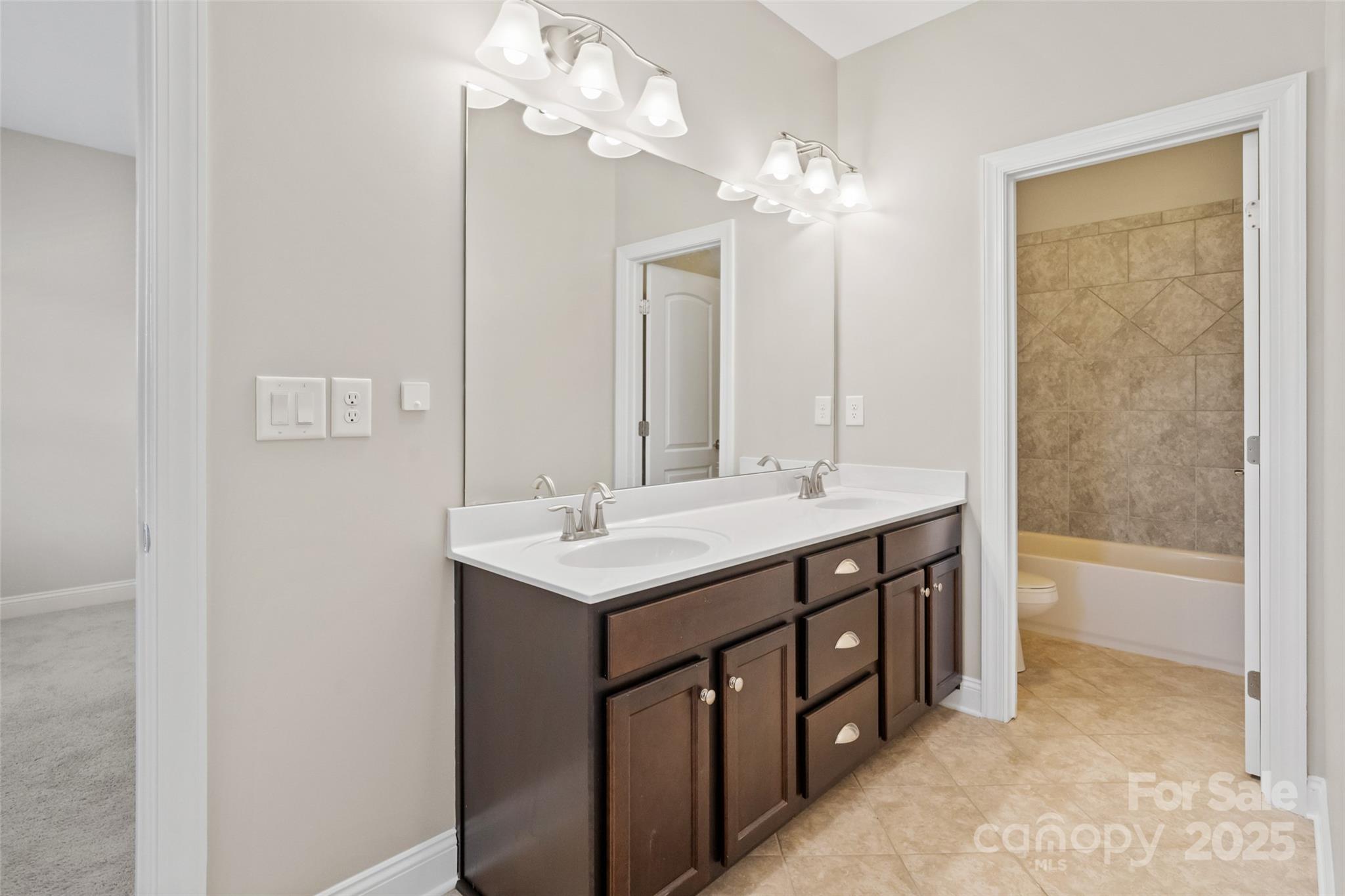 1022 Torrens Drive Monroe, NC 28110 - Photo 40 of 46 a bathroom with a double vanity sink and a mirror
