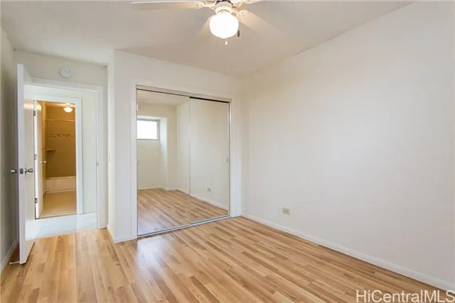 a view of a room with wooden floor and a sink