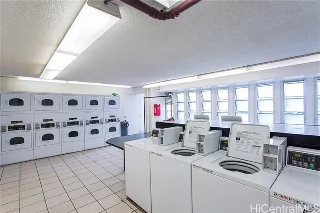 a living room with furniture a flat screen tv and a stove