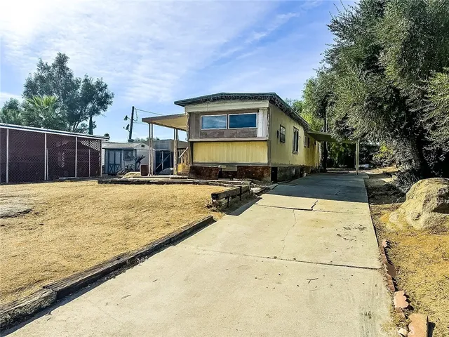 a swimming pool with outdoor seating and yard