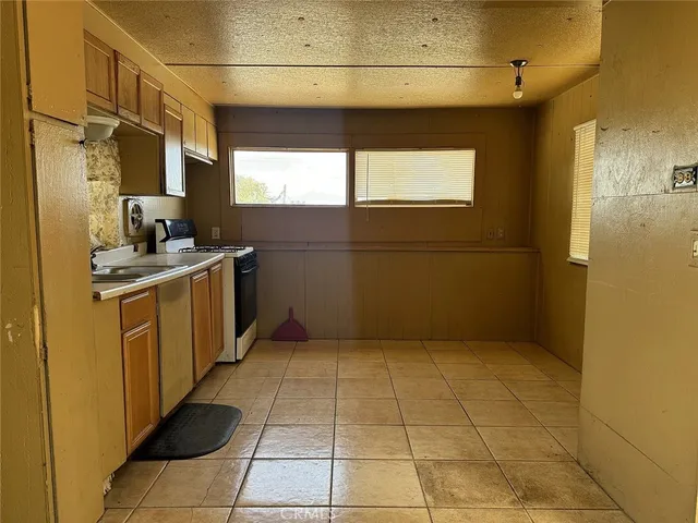 a kitchen with a sink a stove and a refrigerator