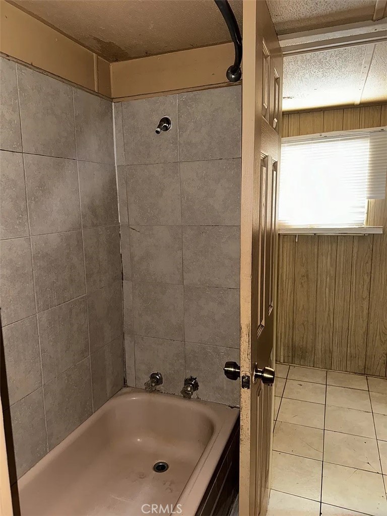 640 Apache Road Perris, CA 92570 - Photo 7 of 10 a bathroom with a tub and a shower