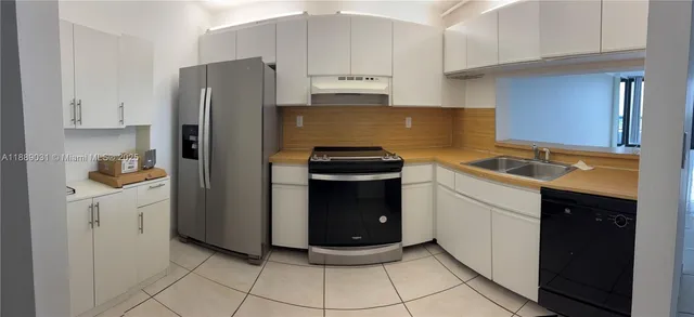 a kitchen with a sink stove and refrigerator