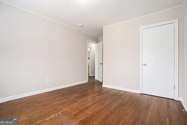 an empty room with wooden floor