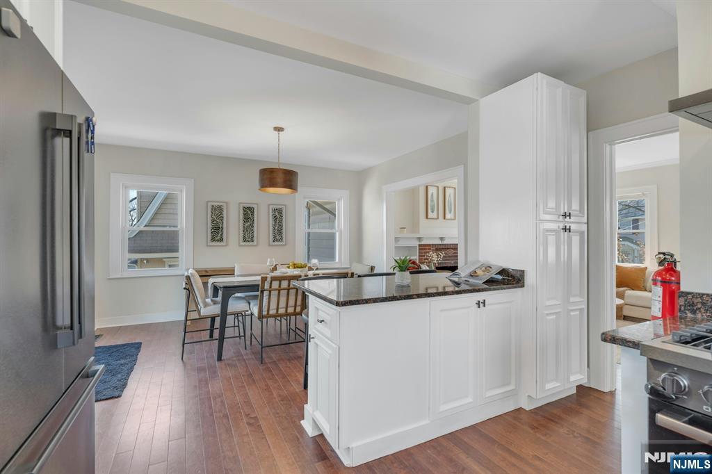 39 Vernon Terrace Bloomfield, NJ 07003 - Photo 16 of 39 a kitchen with granite countertop a table and chairs in it