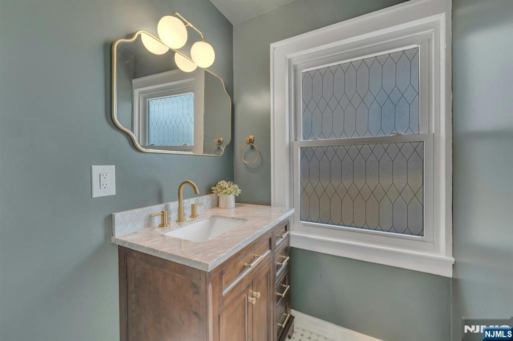 39 Vernon Terrace Bloomfield, NJ 07003 - Photo 6 of 39 a bathroom with a sink and a mirror