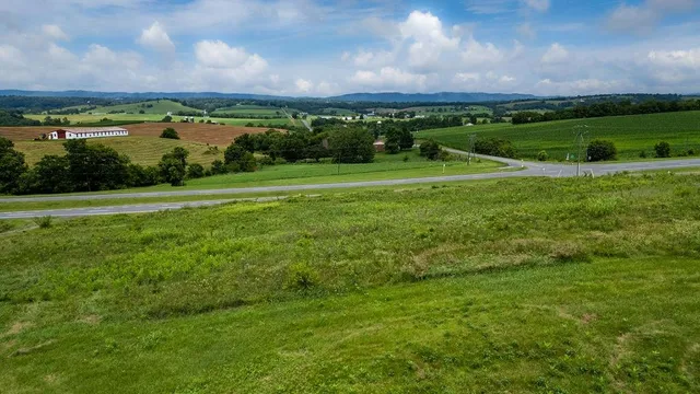 a view of a green field with an ocean view