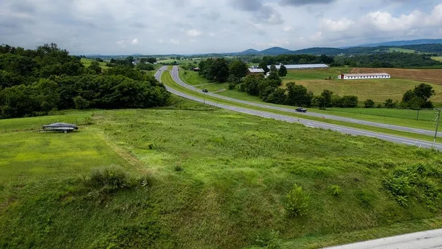 an aerial view of a golf course with a lake view