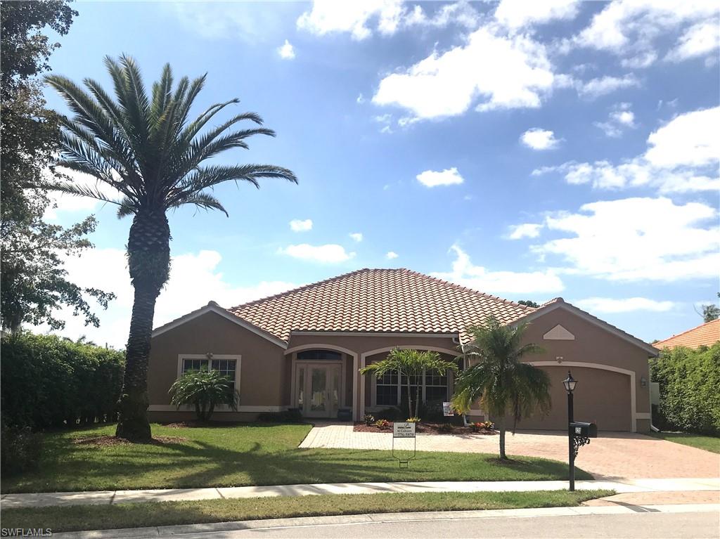 120 Forest Hills Boulevard Naples, FL 34113 - Photo 1 of 24 a front view of a house with a yard