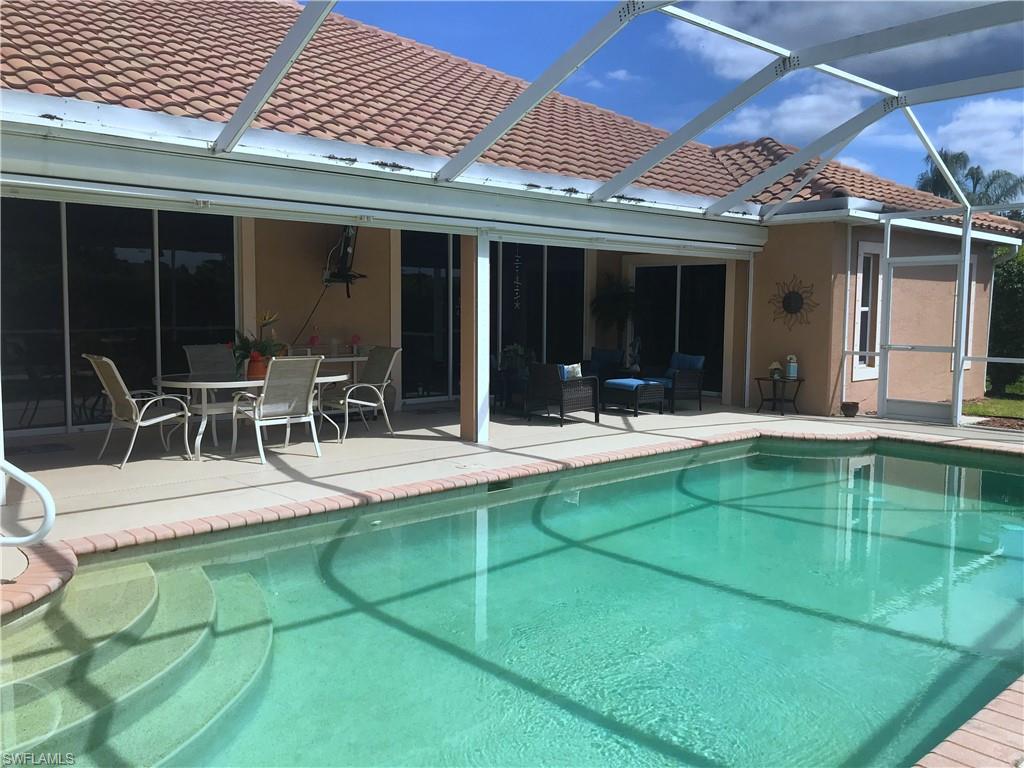 120 Forest Hills Boulevard Naples, FL 34113 - Photo 11 of 24 a view of a patio with table and chairs and potted plants