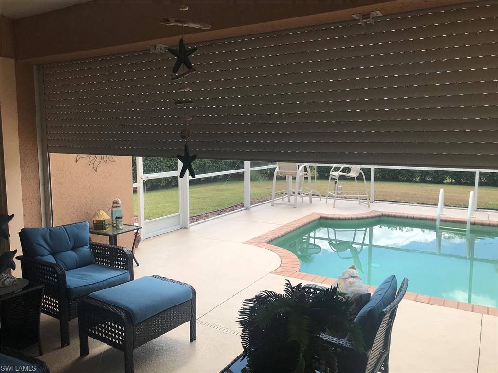 120 Forest Hills Boulevard Naples, FL 34113 - Photo 12 of 24 a view of a chairs and table in the backyard