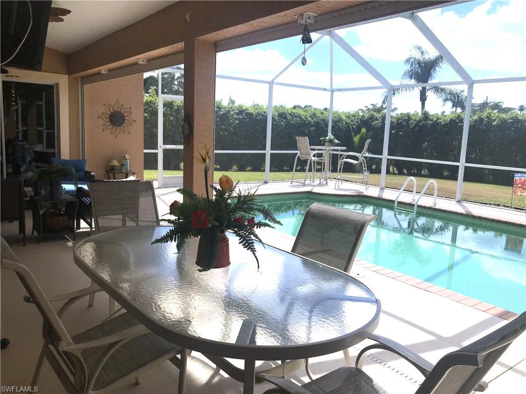 120 Forest Hills Boulevard Naples, FL 34113 - Photo 13 of 24 a view of a dining room with furniture wooden floor and a potted plant