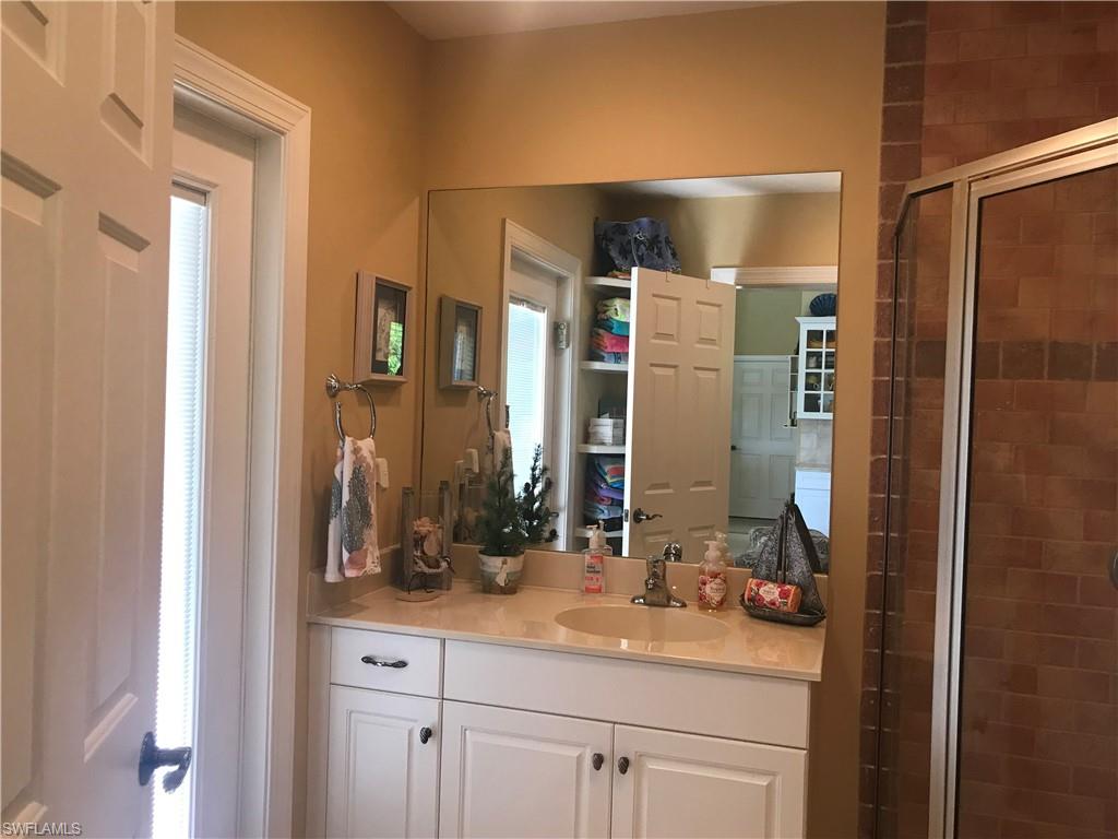 120 Forest Hills Boulevard Naples, FL 34113 - Photo 14 of 24 a bathroom with a sink and a mirror