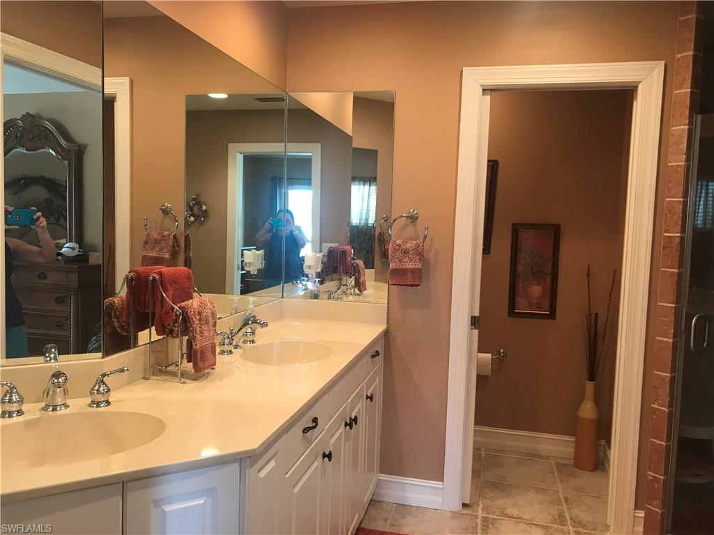 120 Forest Hills Boulevard Naples, FL 34113 - Photo 17 of 24 a bathroom with double vanity sinks and a mirror