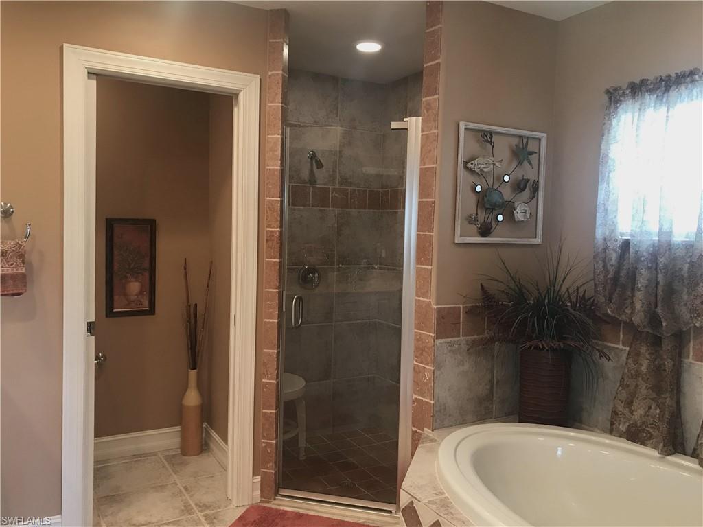 120 Forest Hills Boulevard Naples, FL 34113 - Photo 18 of 24 a bathroom with a toilet and shower
