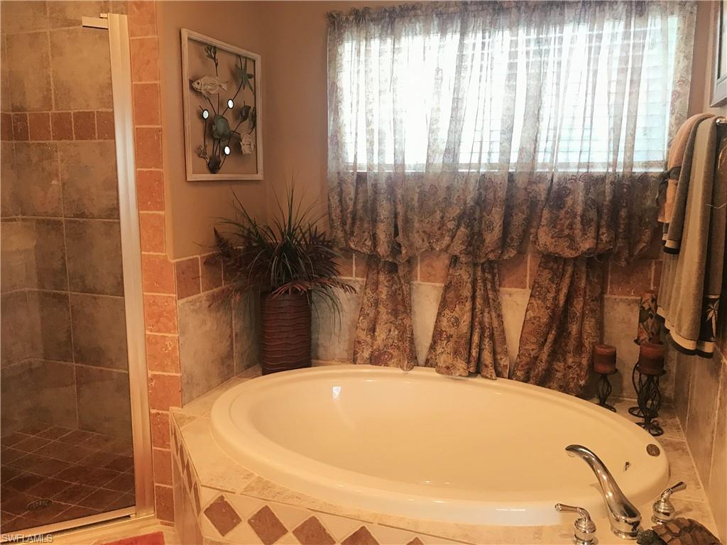 120 Forest Hills Boulevard Naples, FL 34113 - Photo 19 of 24 a bathroom with a bathtub and shower